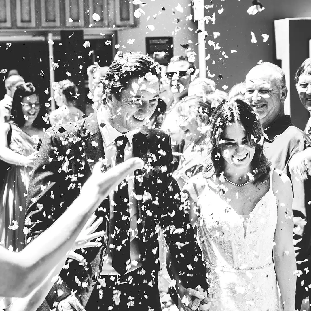 Happy wedding couple leaving the ceremony