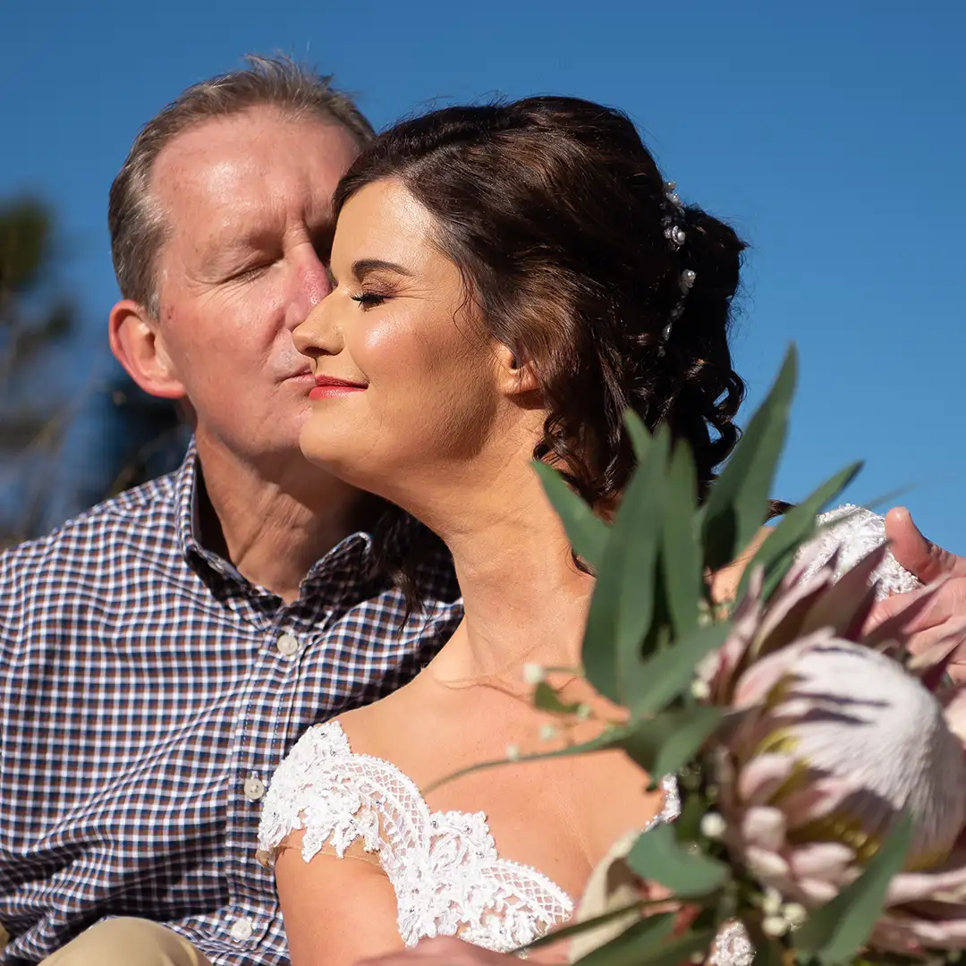 Sunlit wedding couple smiling